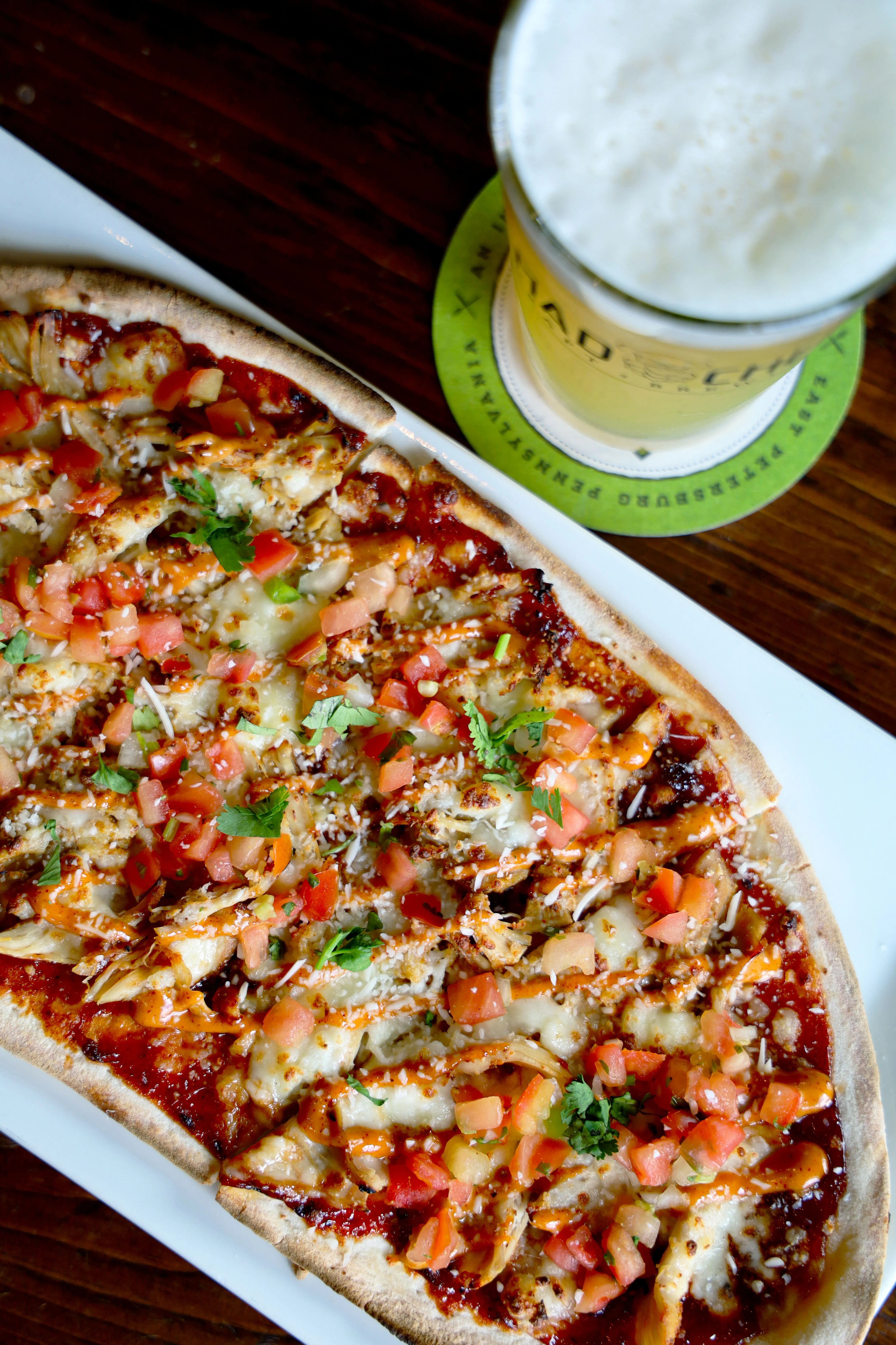 Delicious chicken broccoli Alfredo flatbread topped with cheese and herbs.