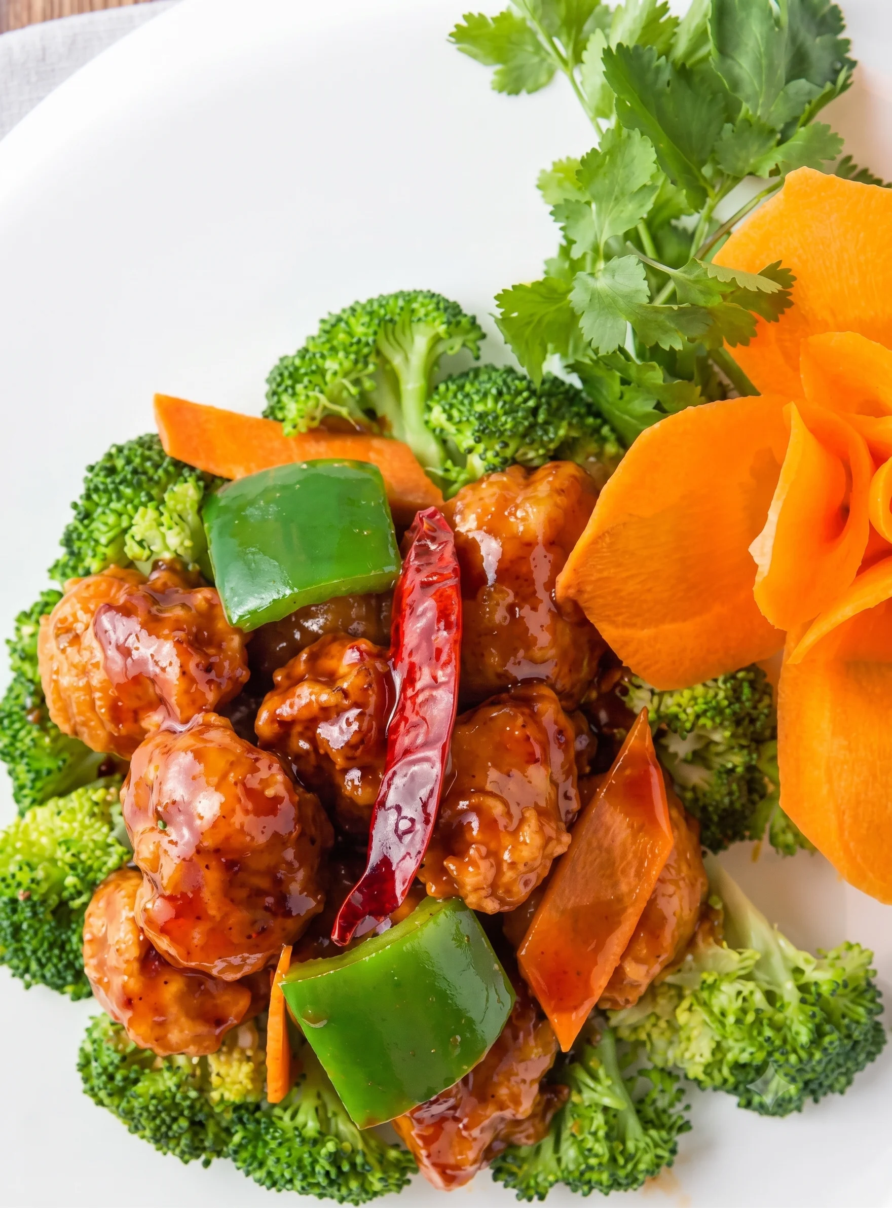 Sweet and sour chicken served on a bed of broccoli