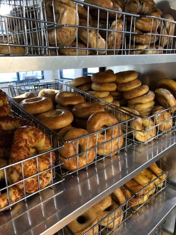 Freshly baked bagels in a bakery display