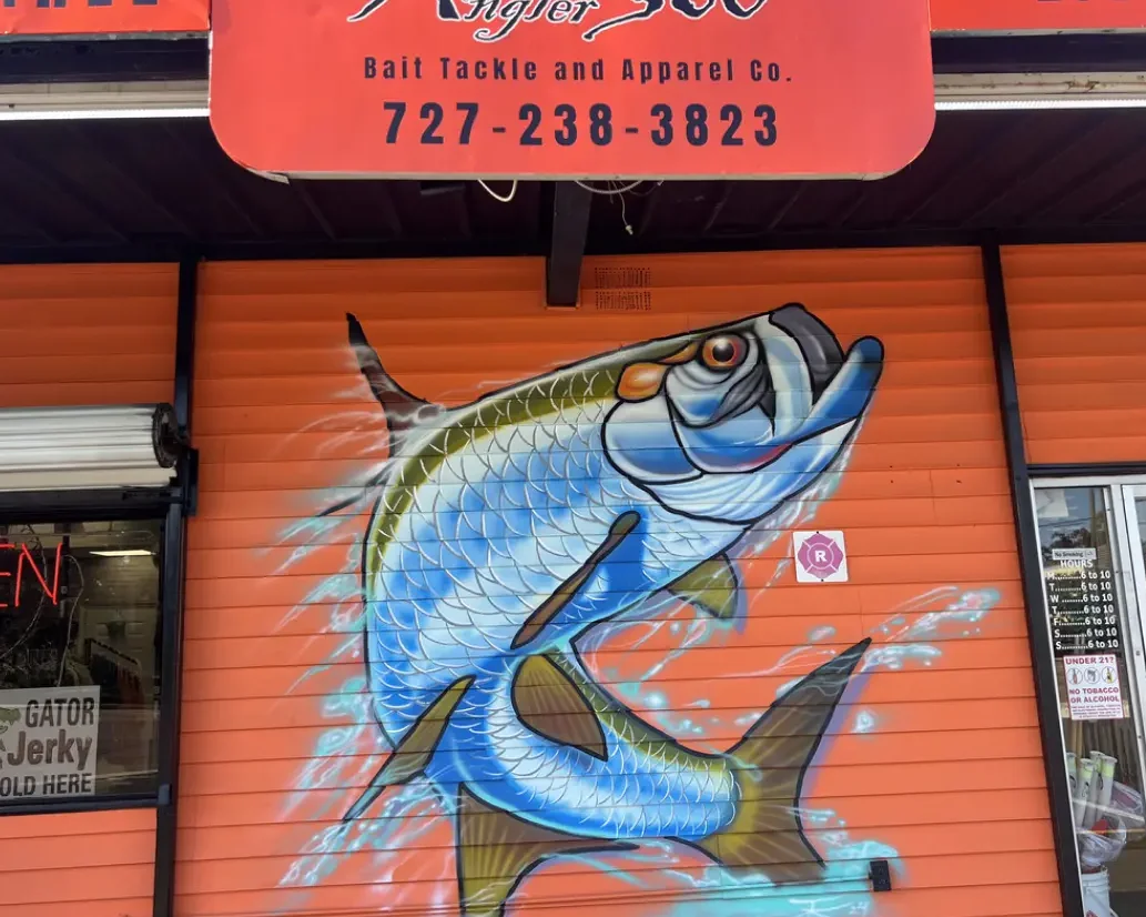 Colorful mural of a fish on a storefront wall