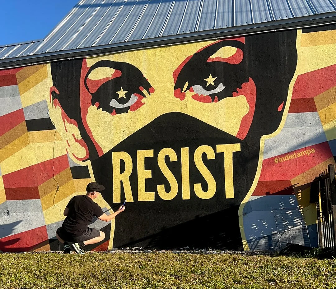 Mural featuring the word 'RESIST' with striking graphic art in Tampa