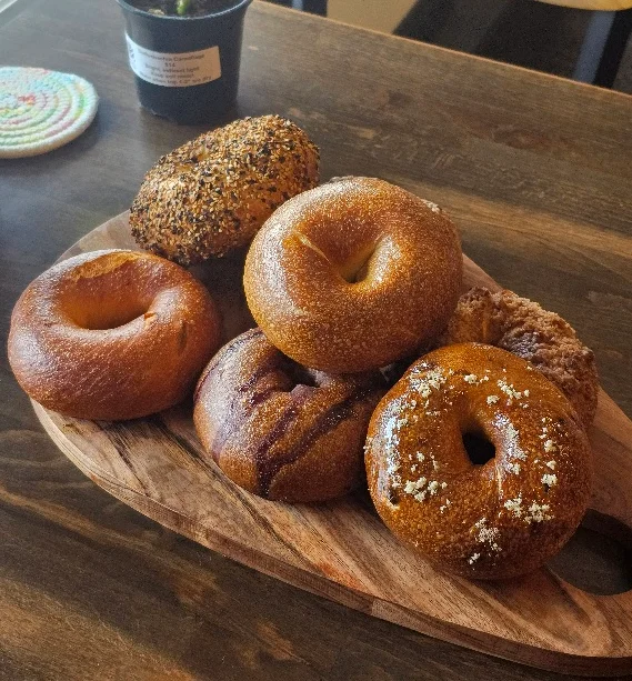 Artisan bagels on a wooden platter
