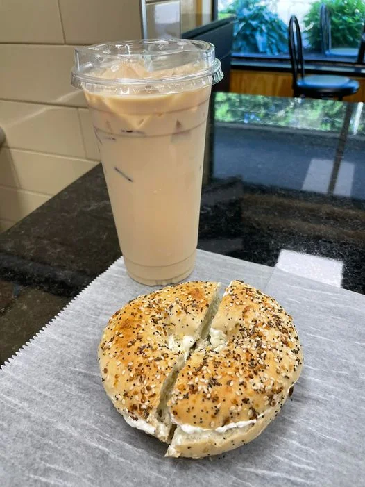 A breakfast bagel with a side of coffee