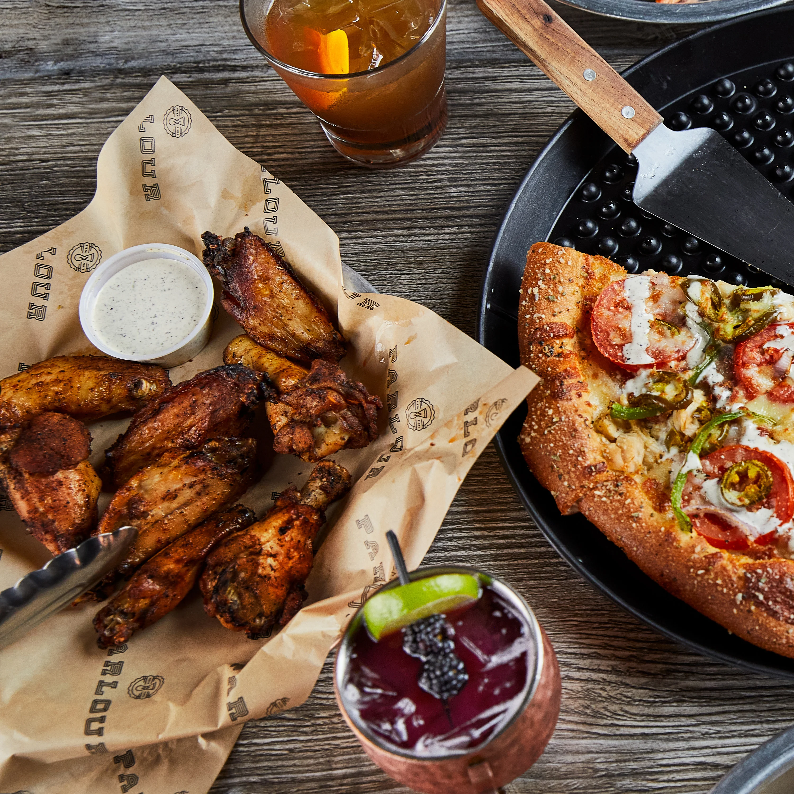 Crispy chicken wings and pizza in a casual dining setting
