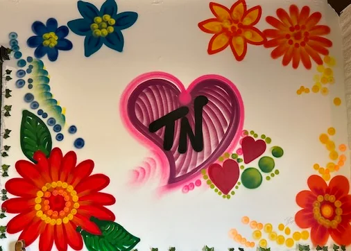 Colorful mural with flowers and heart design in a restaurant