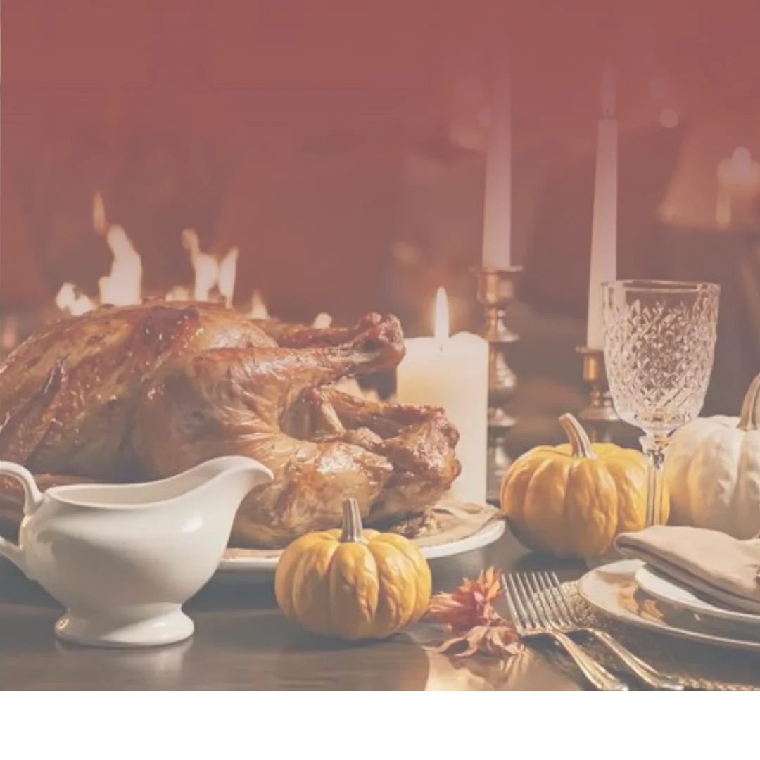 Thanksgiving roast turkey dinner with pumpkins and candlelit table