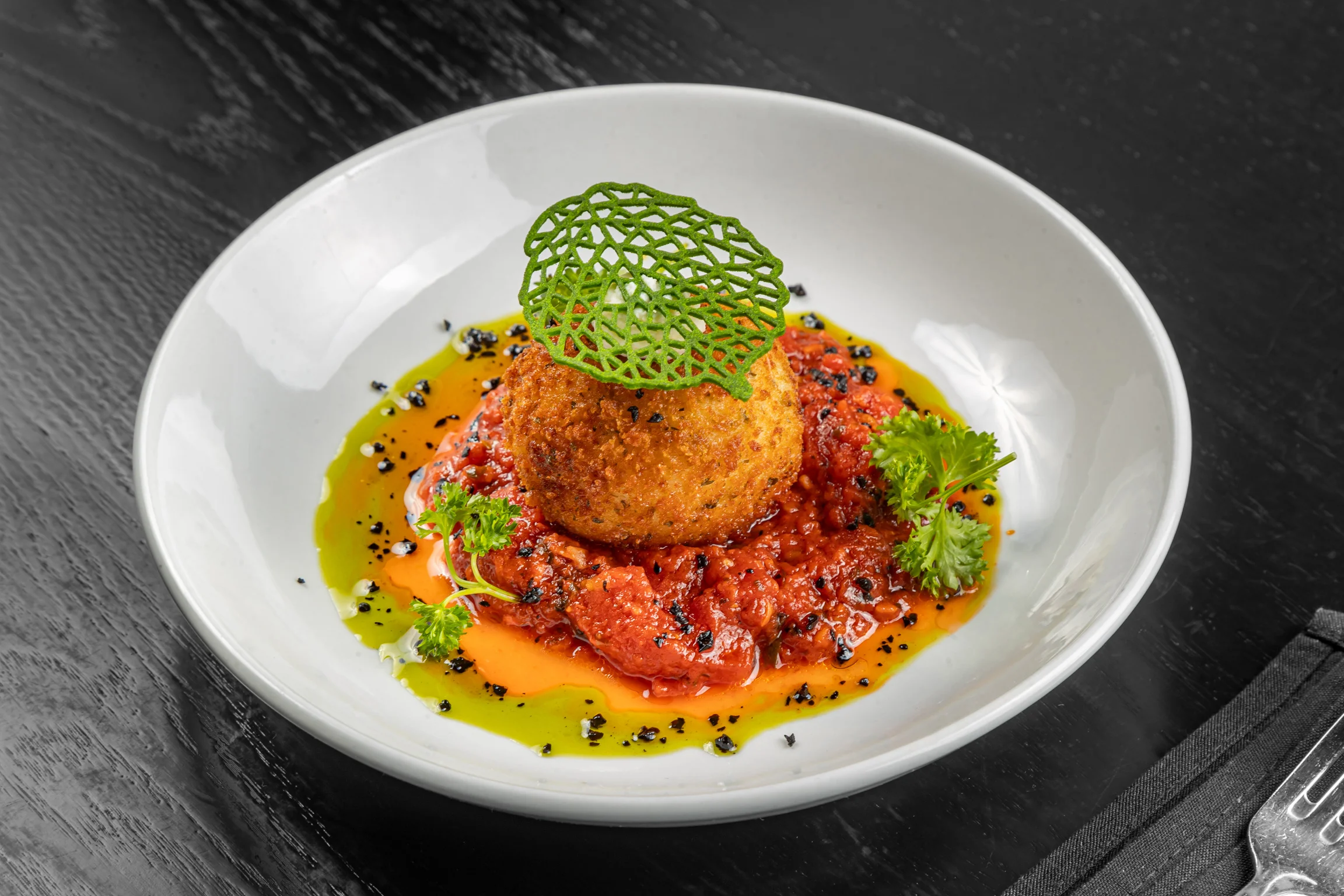 Crispy arancini served on a rich tomato sauce