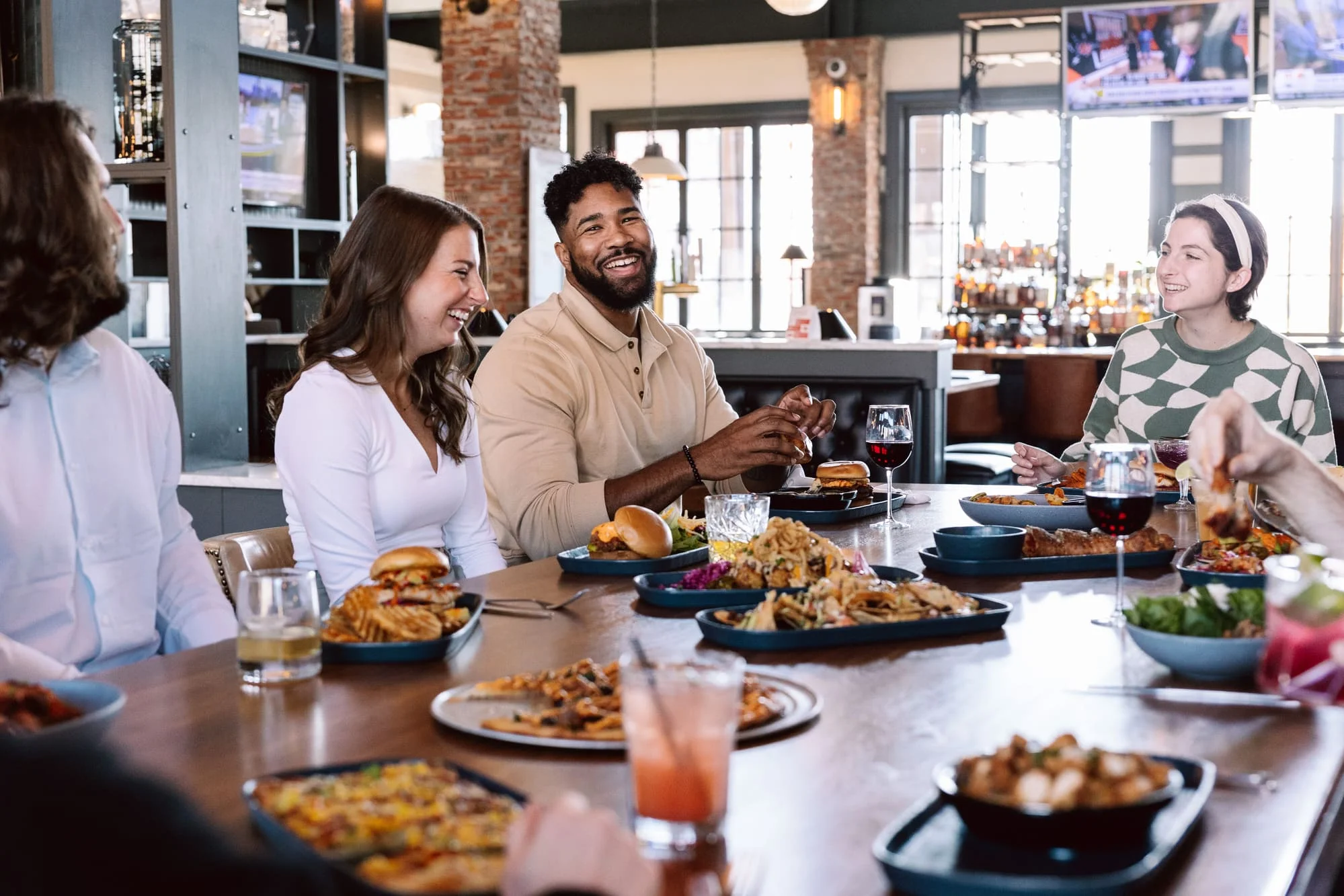 Group enjoying a variety of dishes in a modern restaurant setting