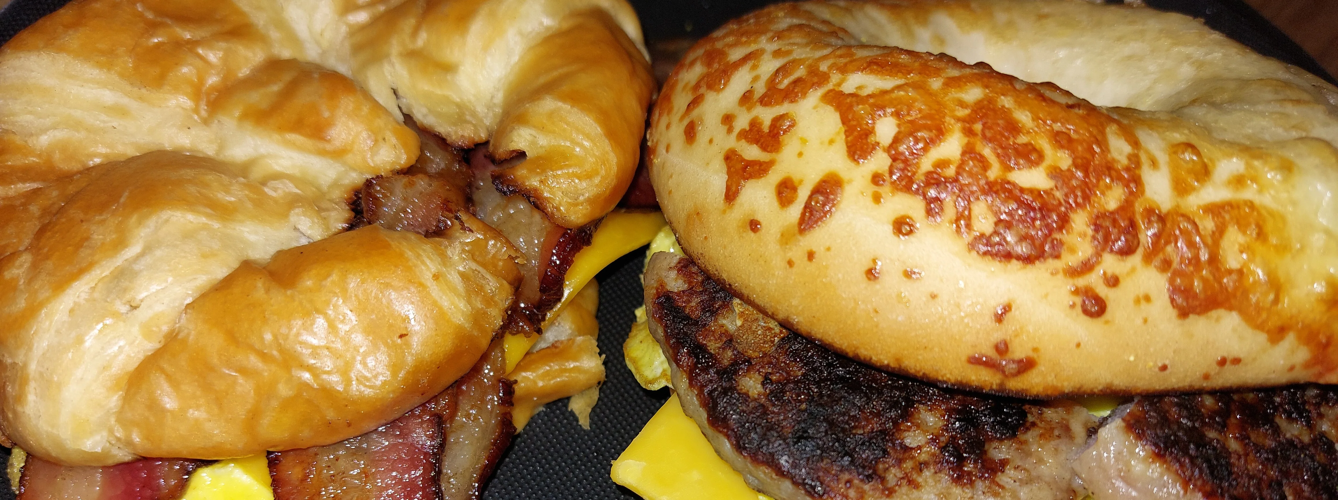 Breakfast sandwiches on flaky croissants and bagels