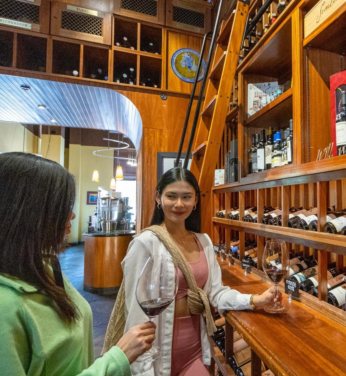 two friends enjoying a glass of wine within side door