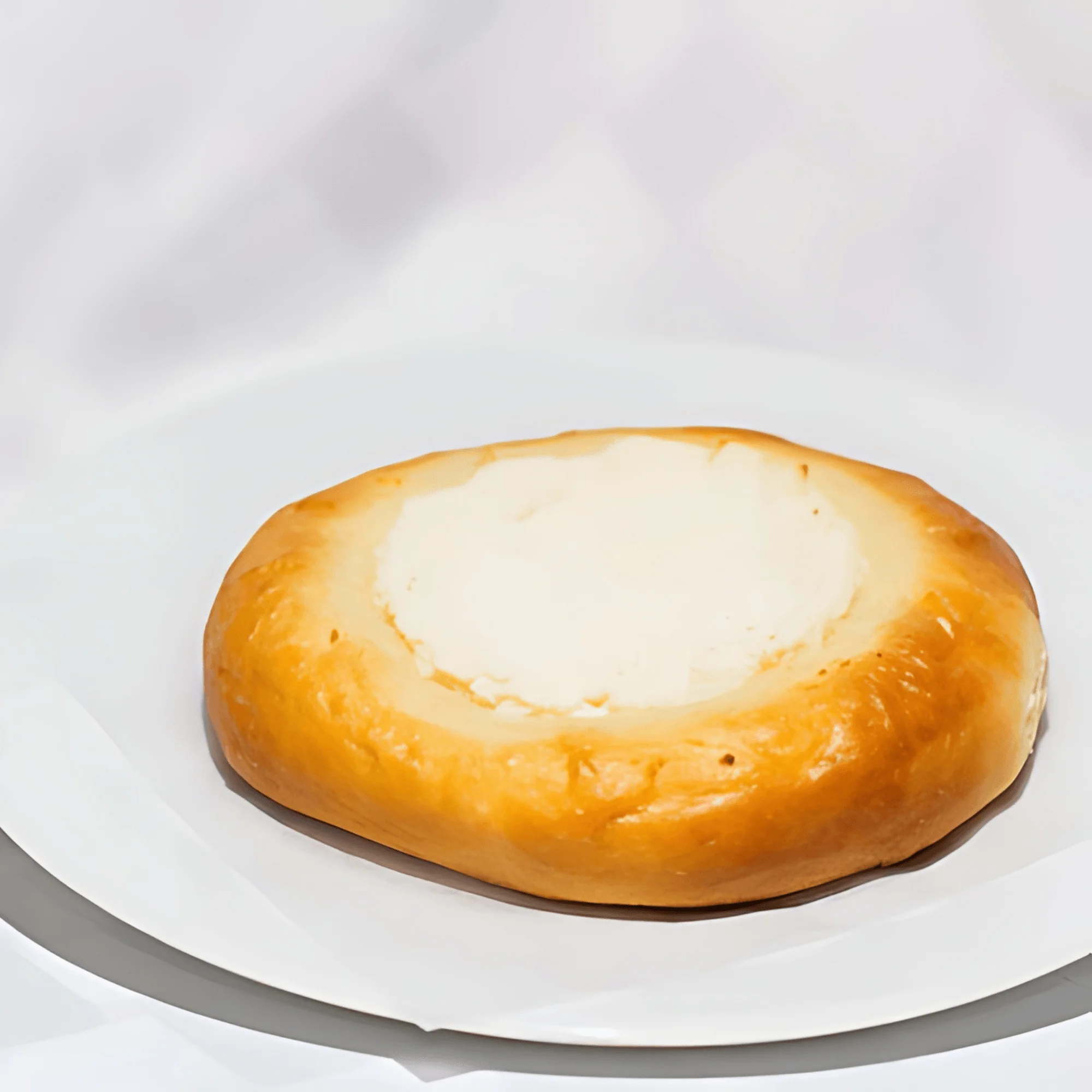 Delicious Russian kulich with creamy filling on a white plate
