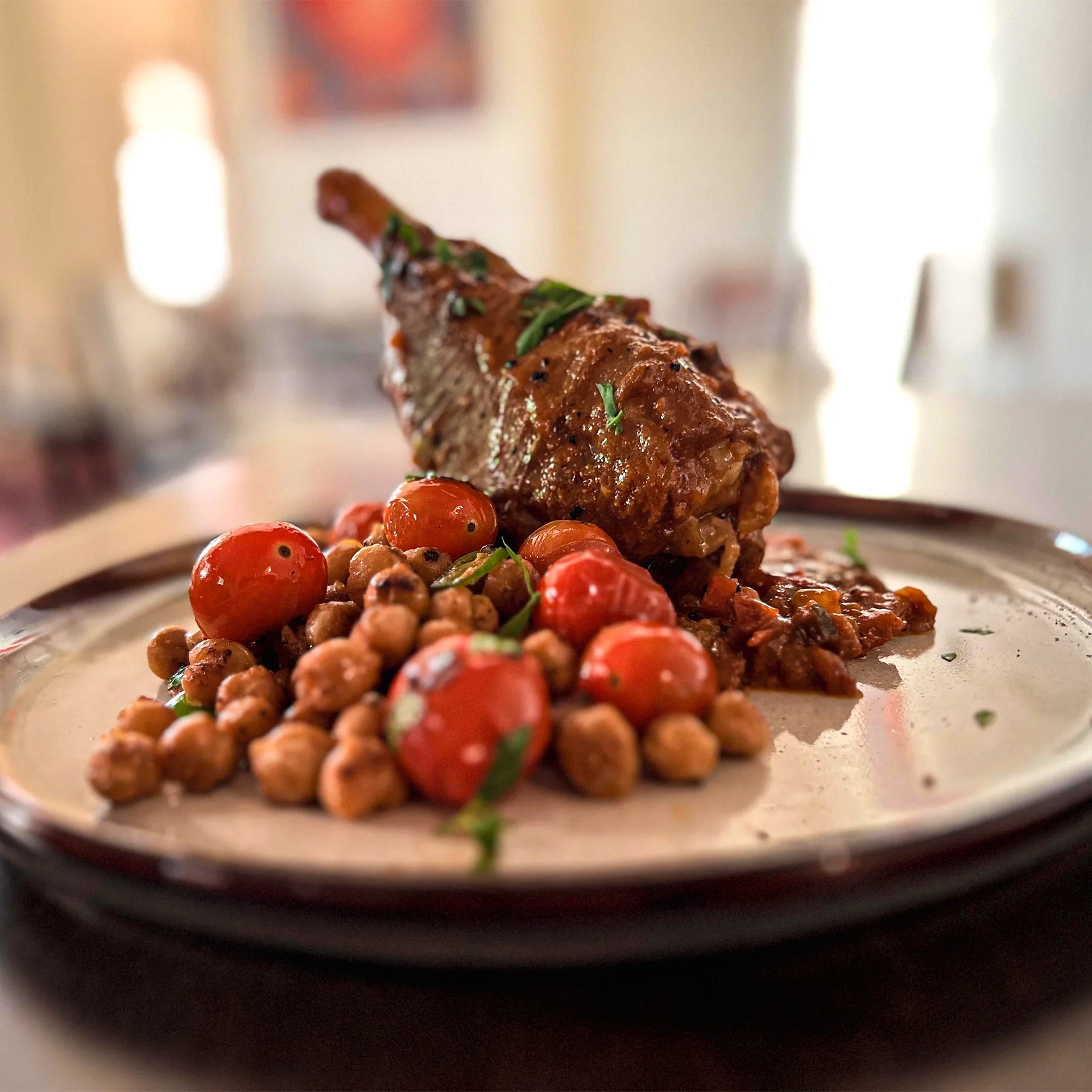 Moroccan lamb tagine with chickpeas and cherry tomatoes on a plate