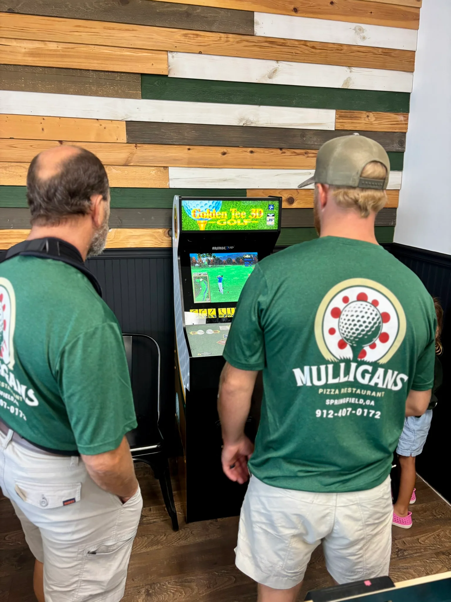 Guests enjoying a retro arcade game in a restaurant setting
