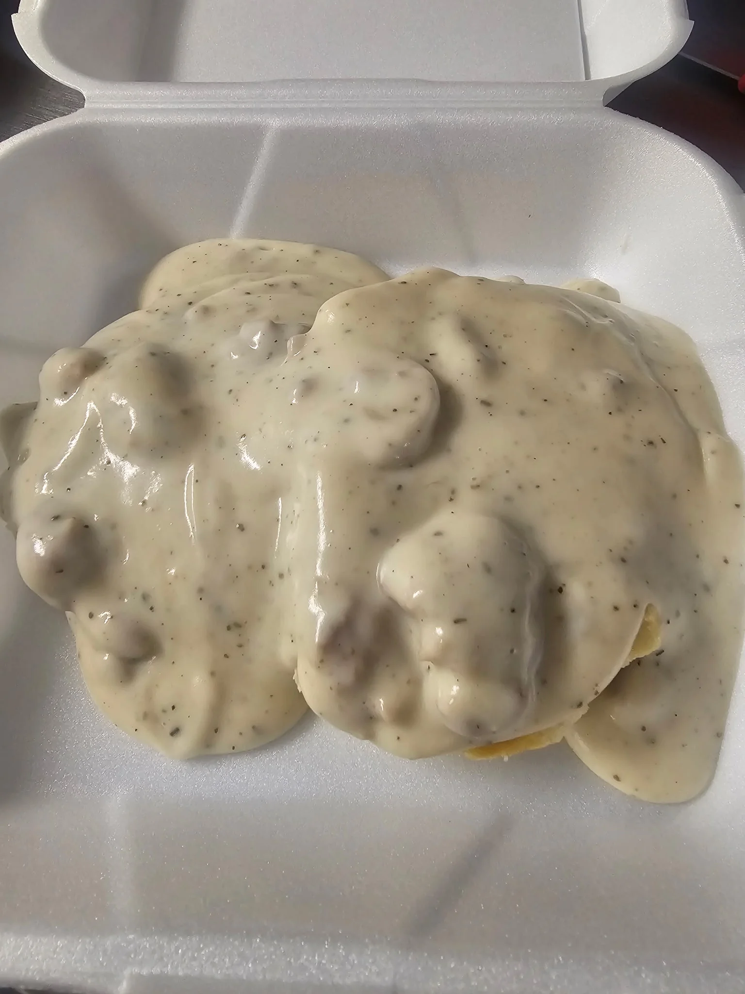 Southern biscuits and gravy served in a takeout container