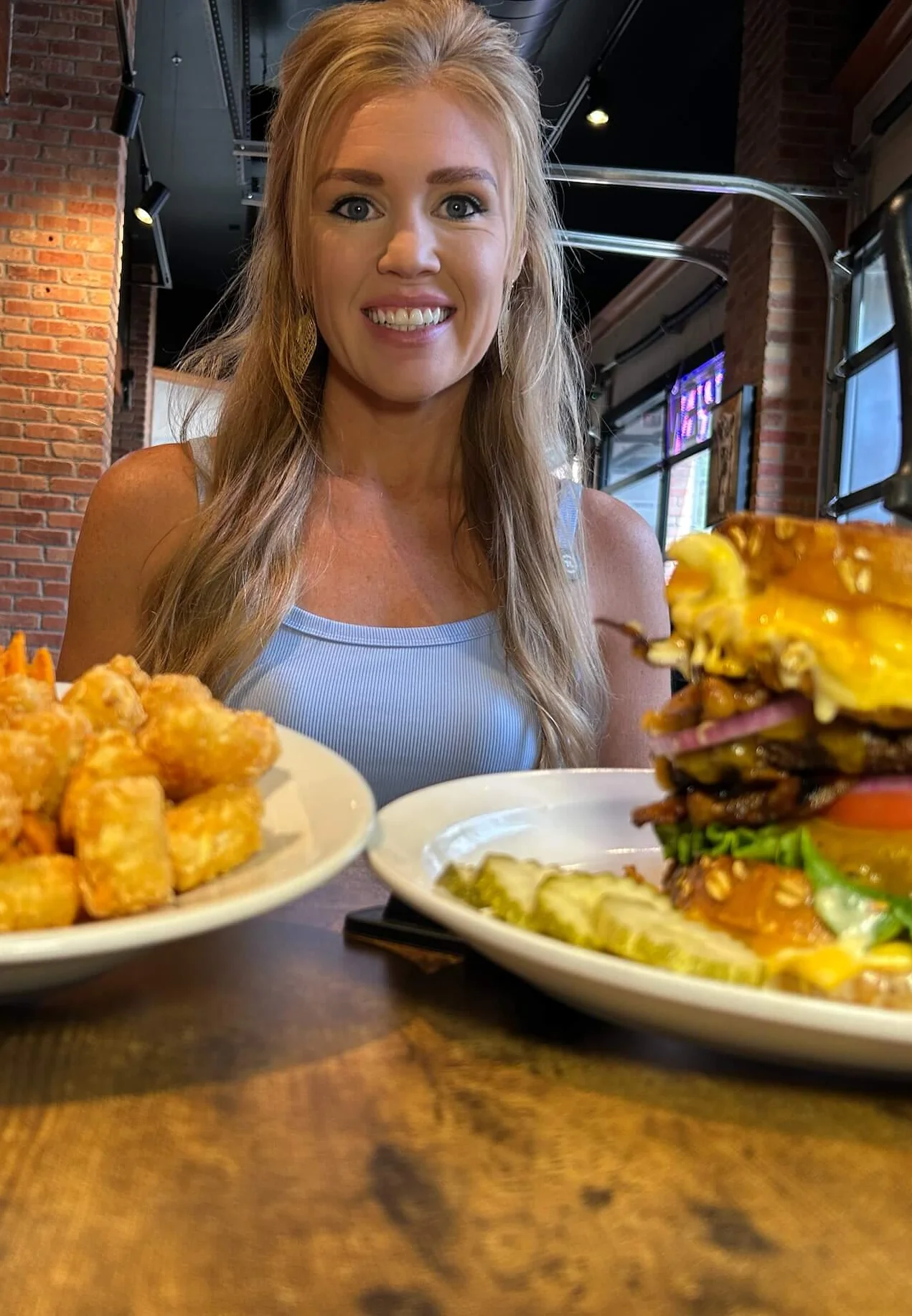 Gourmet cheeseburger with sweet potato fries in a cozy restaurant setting