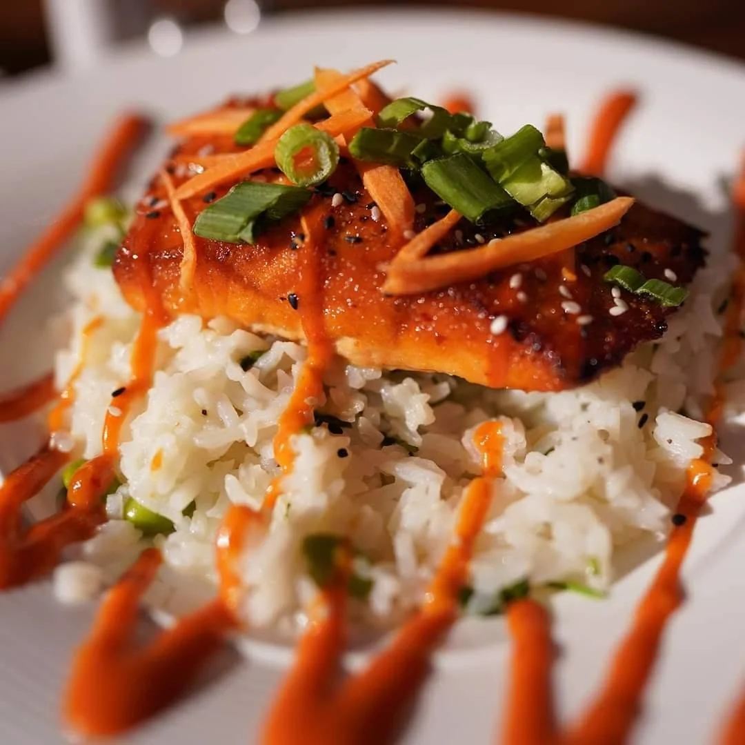 Grilled salmon on rice with spicy sauce