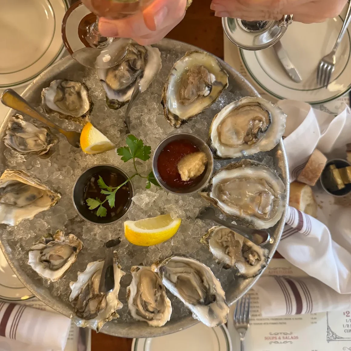 Freshly shucked oysters on ice with lemon and cocktail sauce