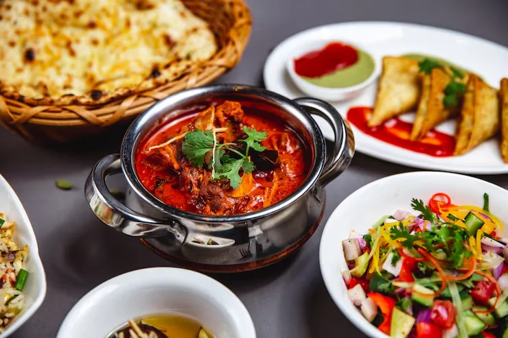 Authentic Indian chicken curry with naan and assorted sides