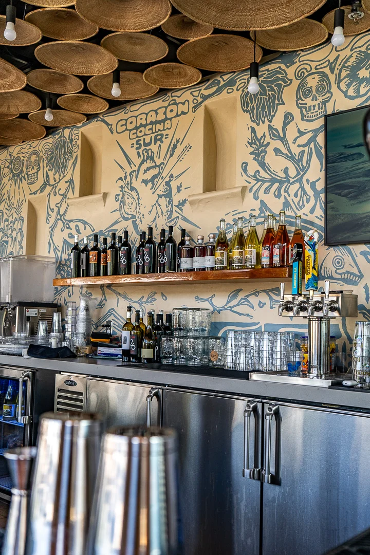 Colorful bar counter with drinks and artistic wall decor