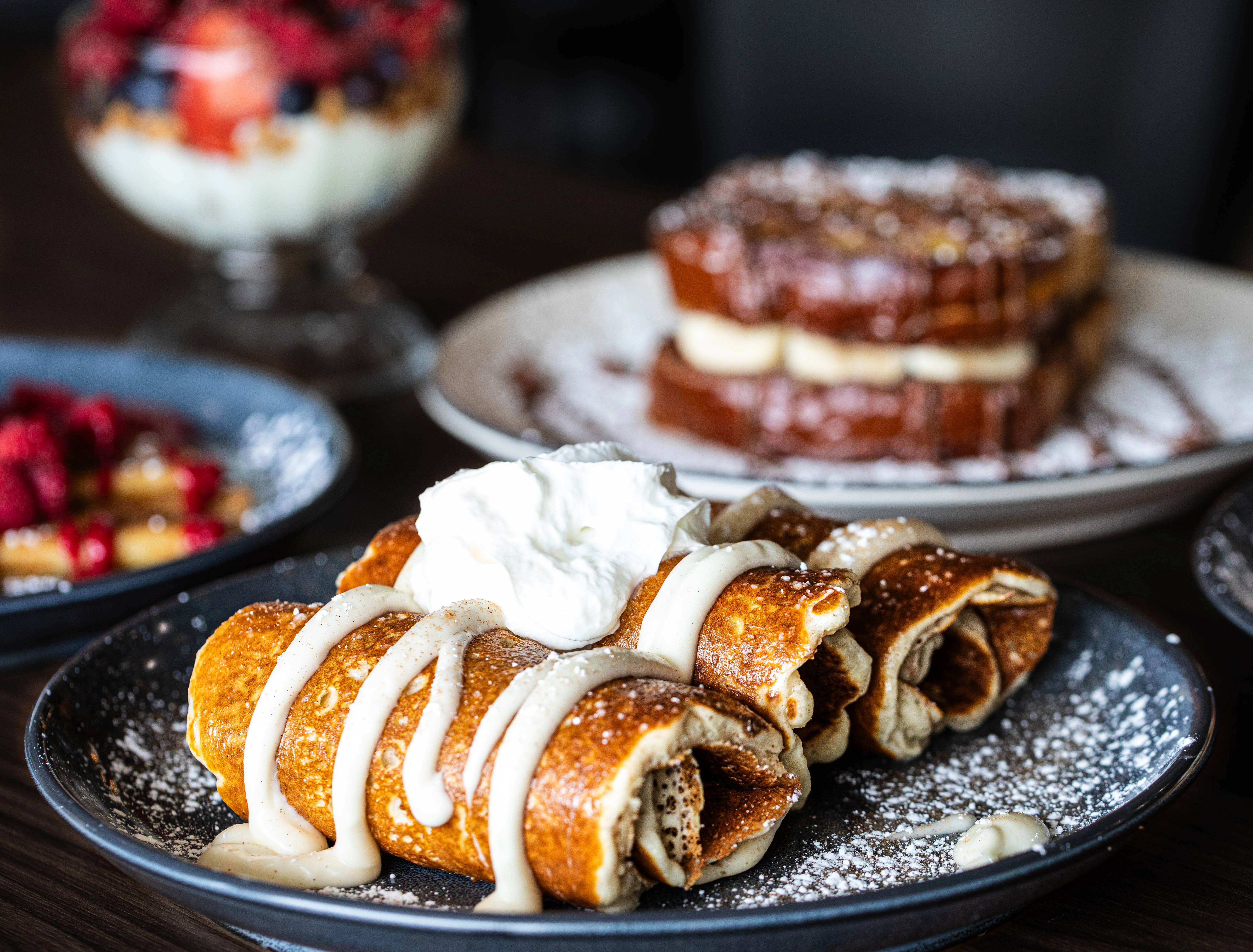 Pancakes rolled up with cream and whipped cream on top