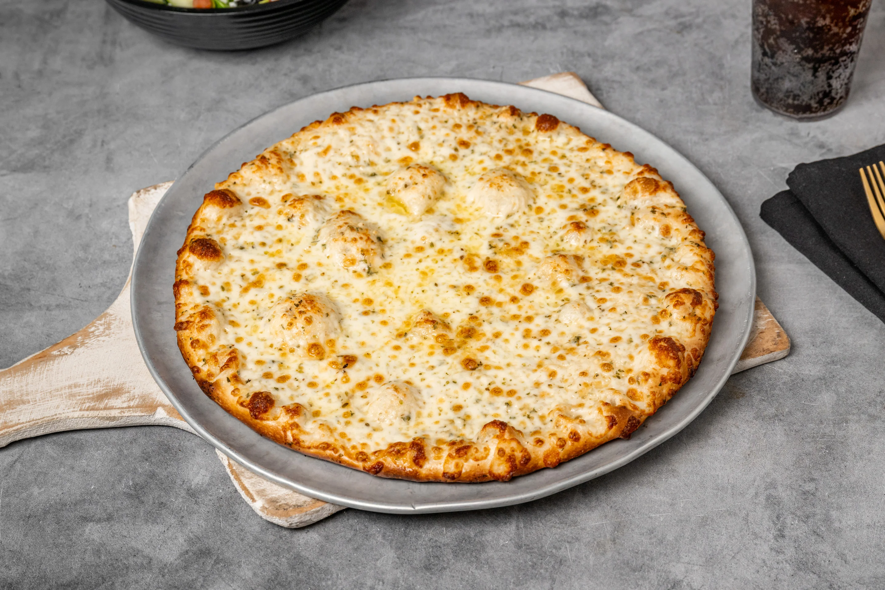 Cheesy white pizza on a metal tray