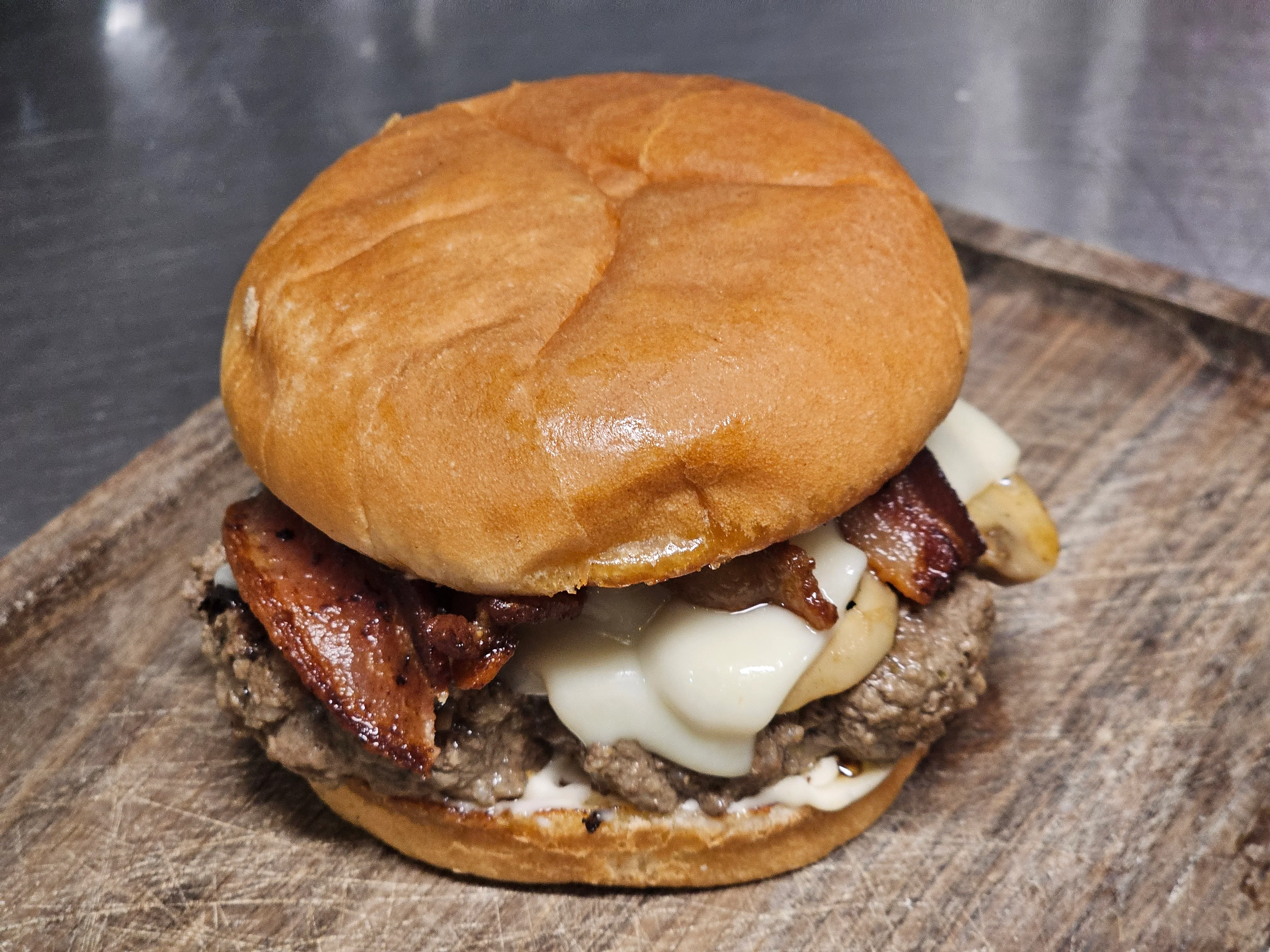 Juicy cheeseburger with bacon on a toasted bun