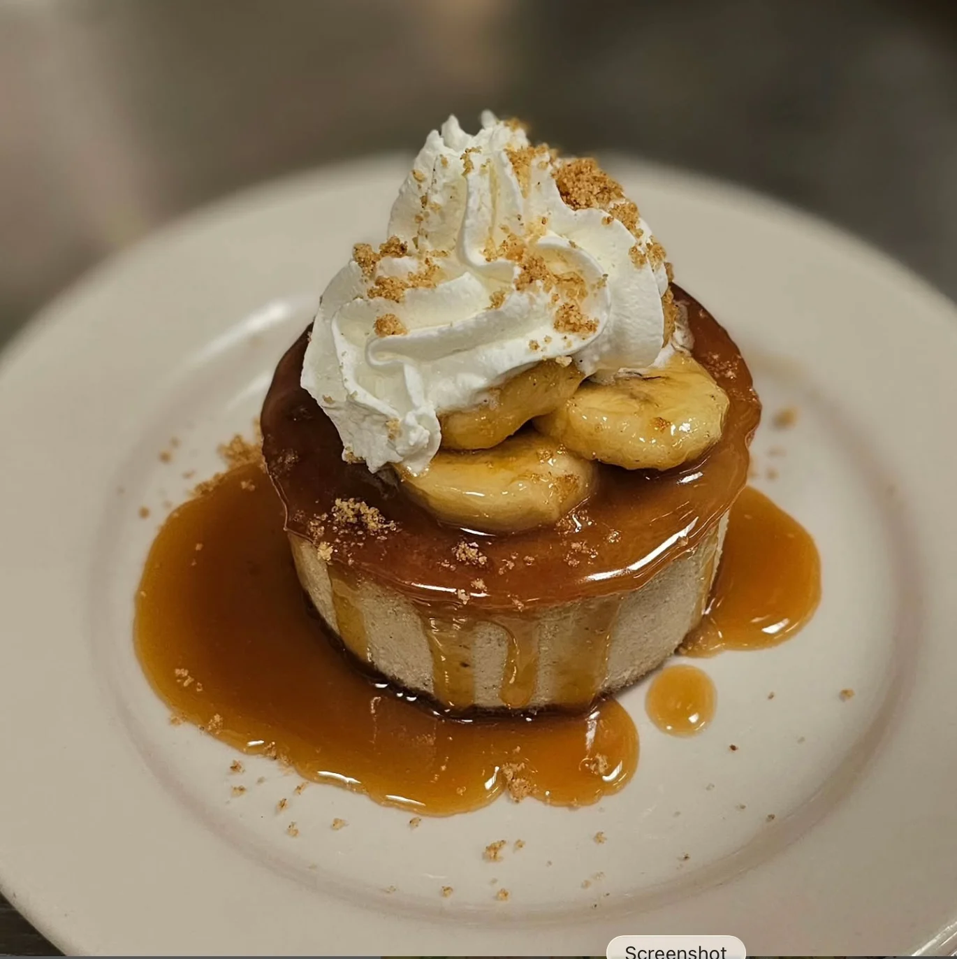 Banoffee cheesecake with caramel sauce and whipped cream