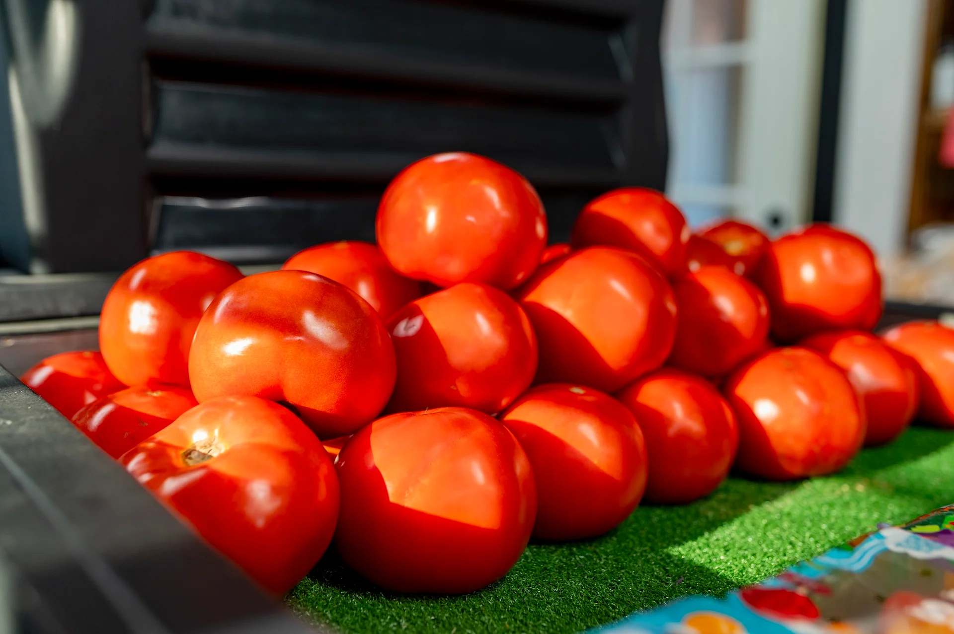 Fresh red tomatoes stacked for sale at a market