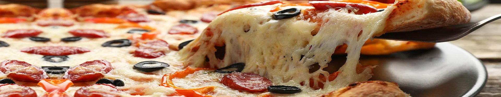 Cheesy pepperoni pizza with olives and bell peppers