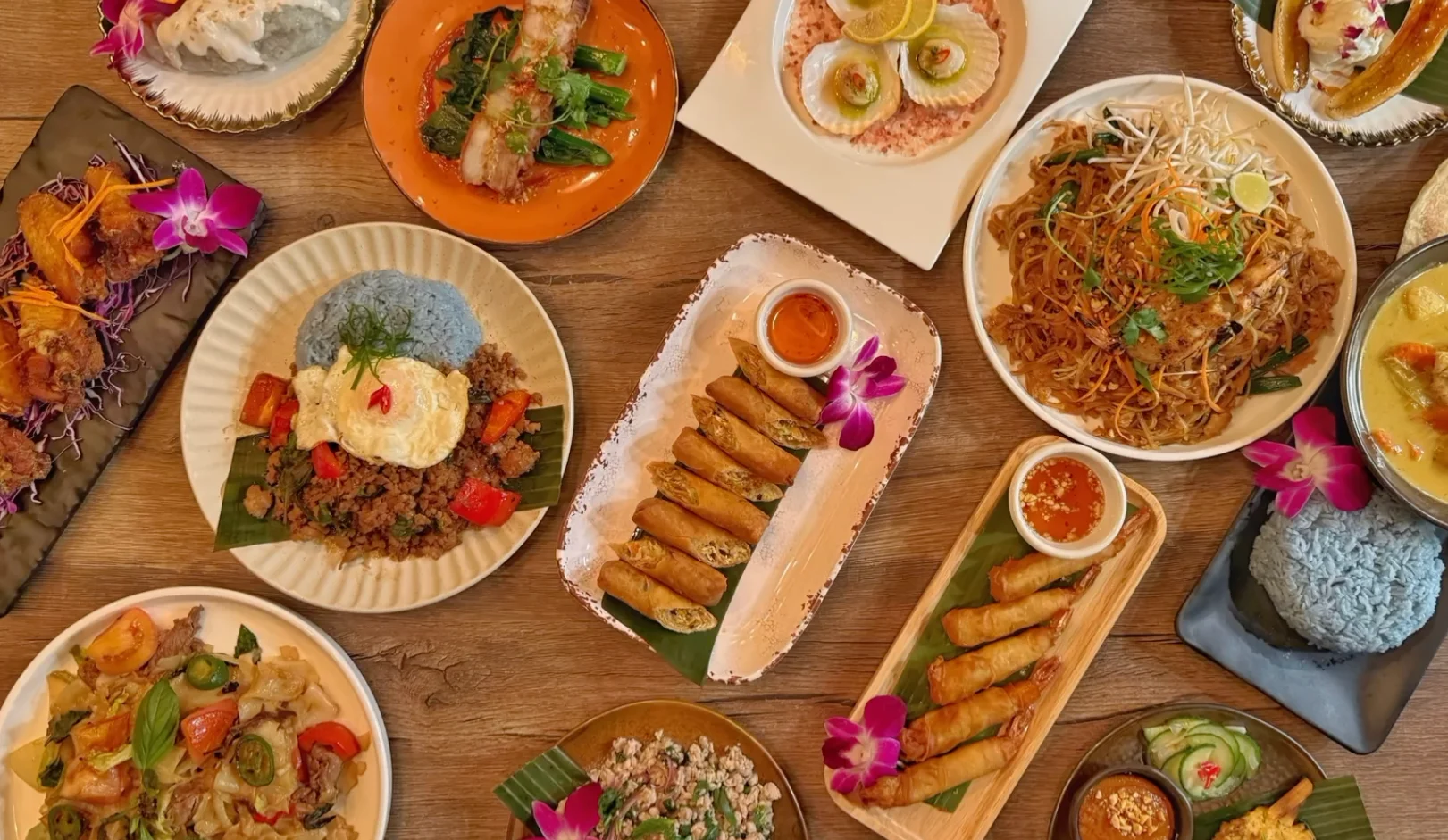Assorted Thai dishes including pad thai and spring rolls