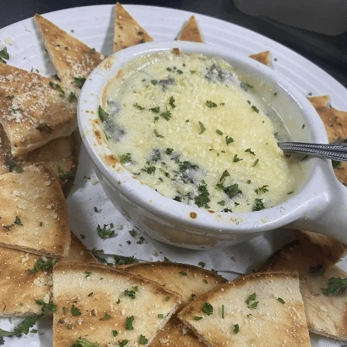 Creamy spinach artichoke dip with crispy pita chips