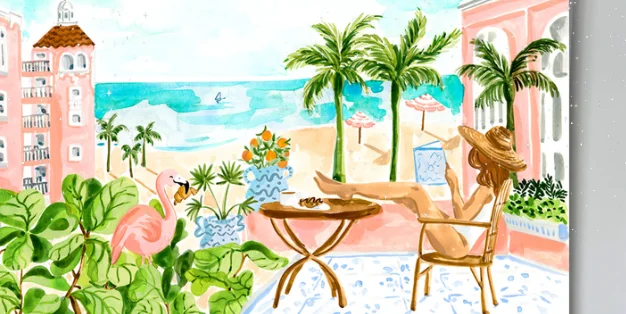 Tropical beach view with pink buildings and outdoor seating