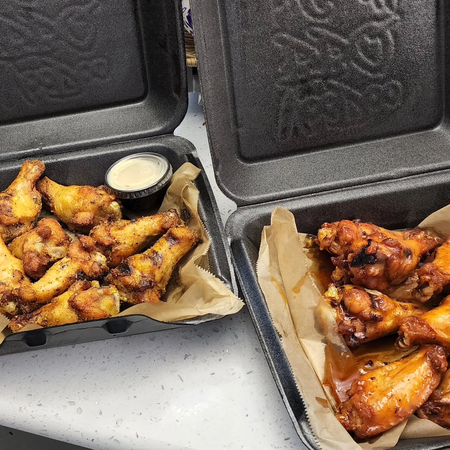 Takeout order of Cajun BBQ wings in to-go box
