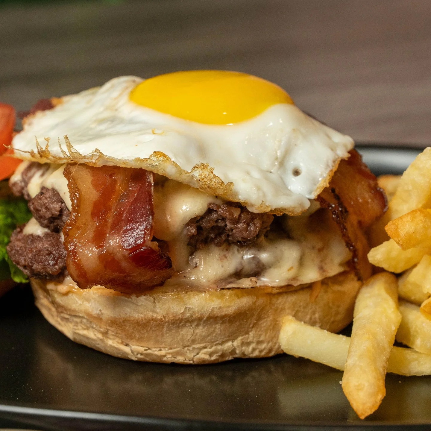 Delicious American cheeseburger with fried egg and bacon