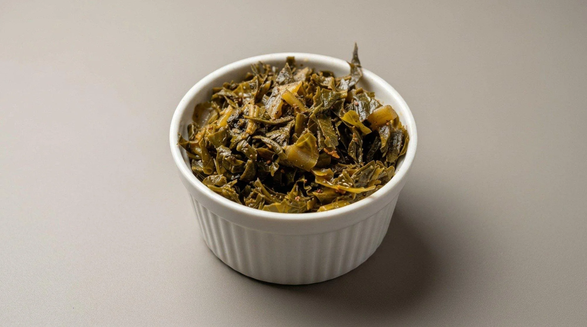 Southern-style collard greens in a white bowl