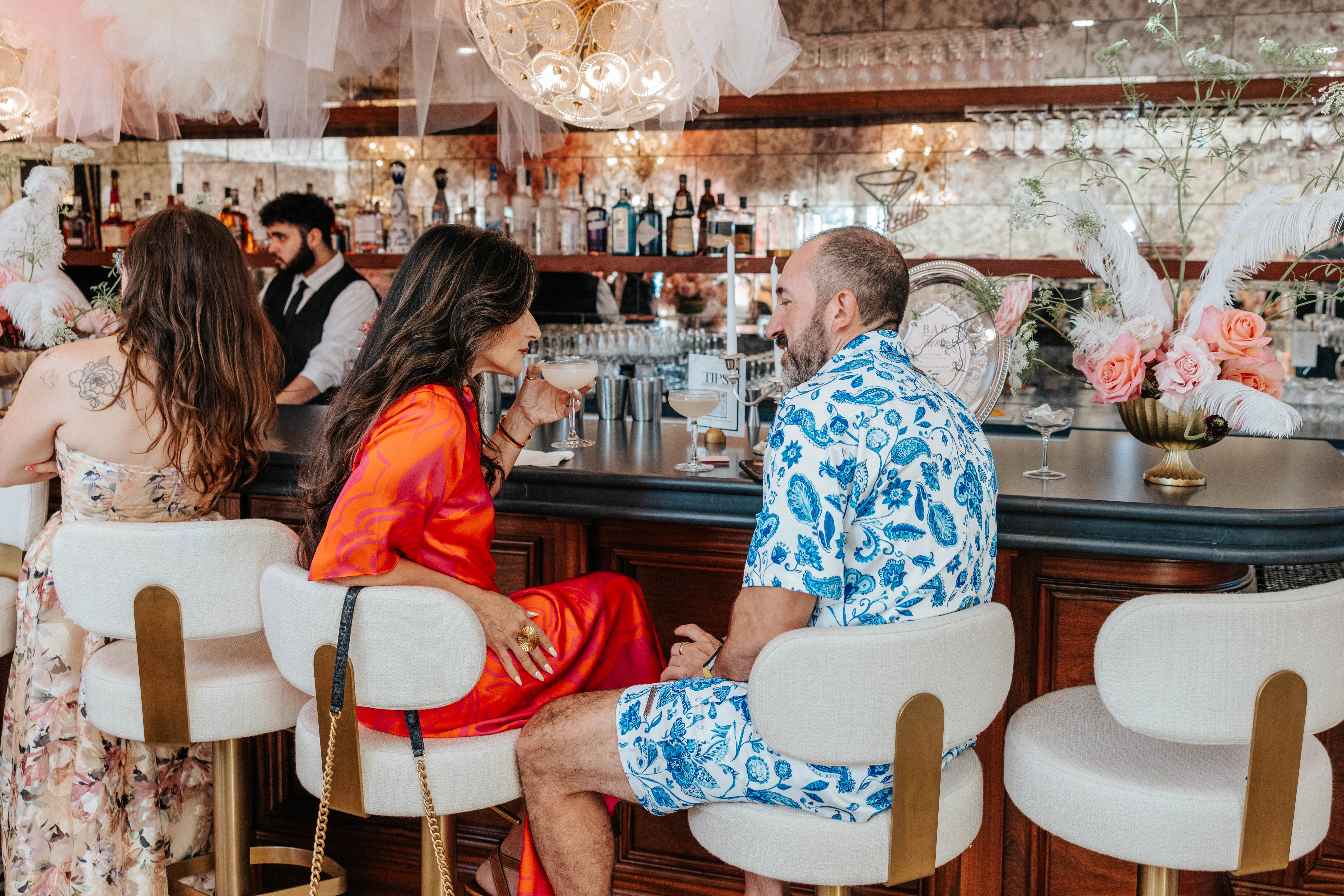 Couple enjoying cocktails at a stylish bar
