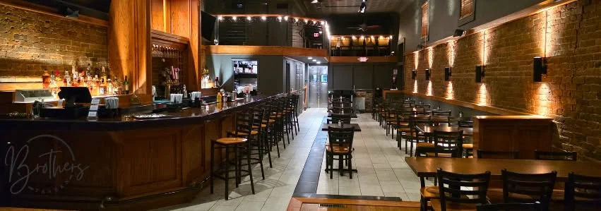 Cozy restaurant interior with exposed brick and warm lighting