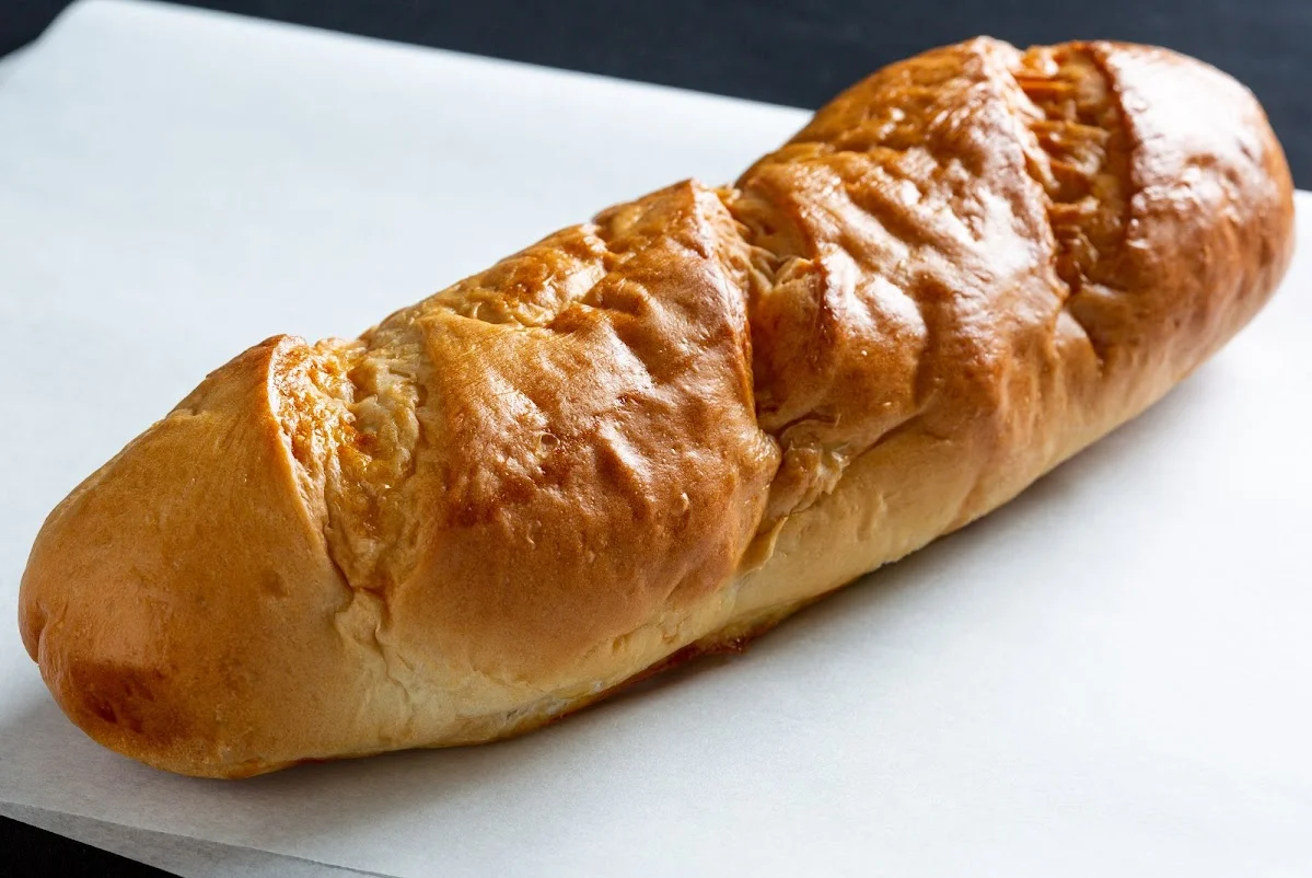Freshly baked Italian focaccia bread on parchment paper