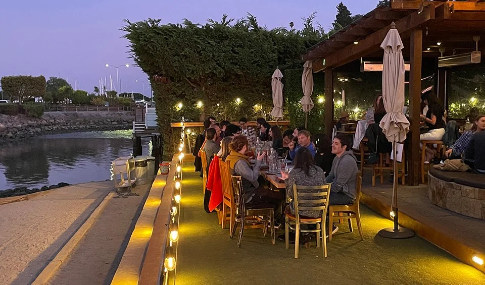 Bar Bocce Green space area at night, tables set up outside to seat up to 30 people