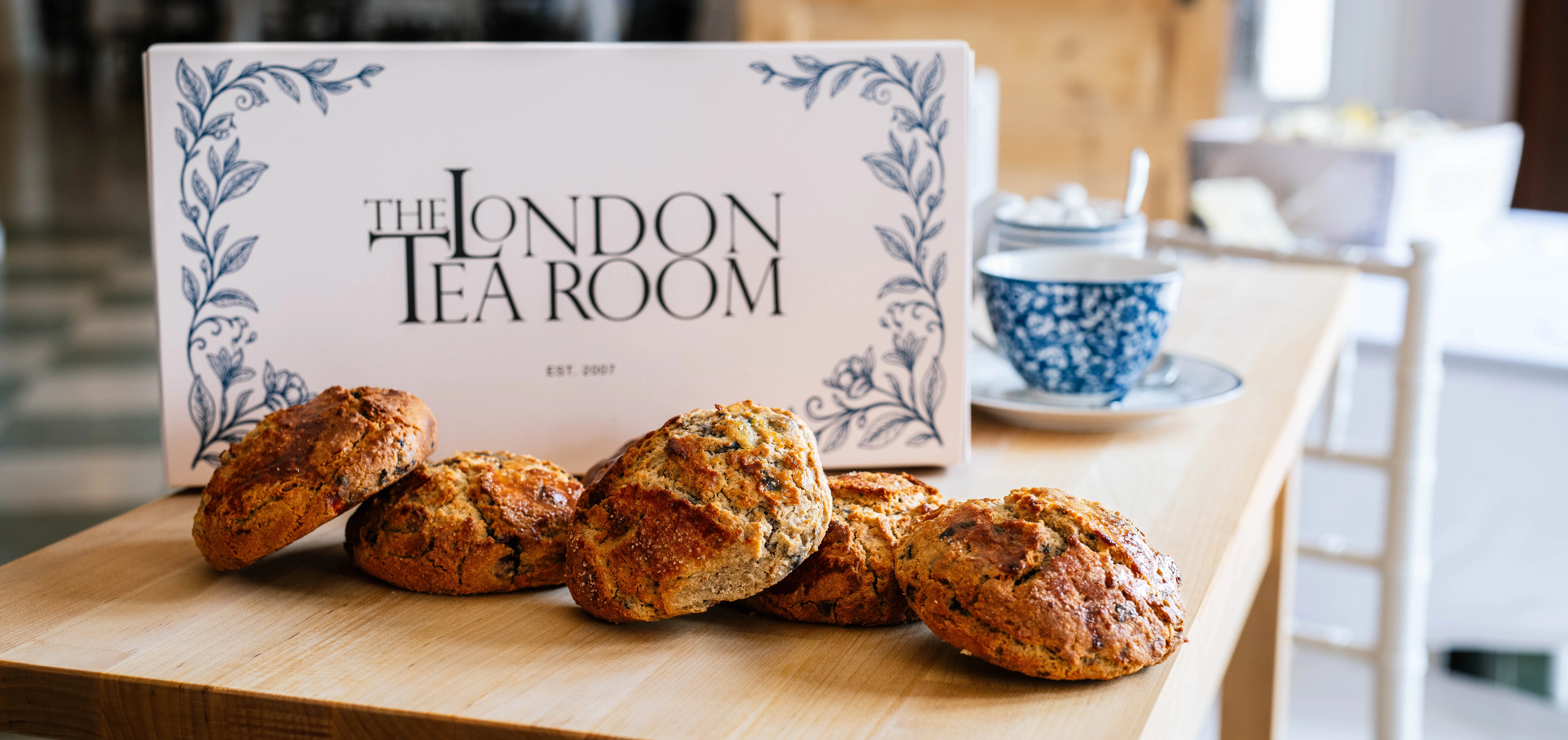 Bakery box with a half dozen scones displayed in front