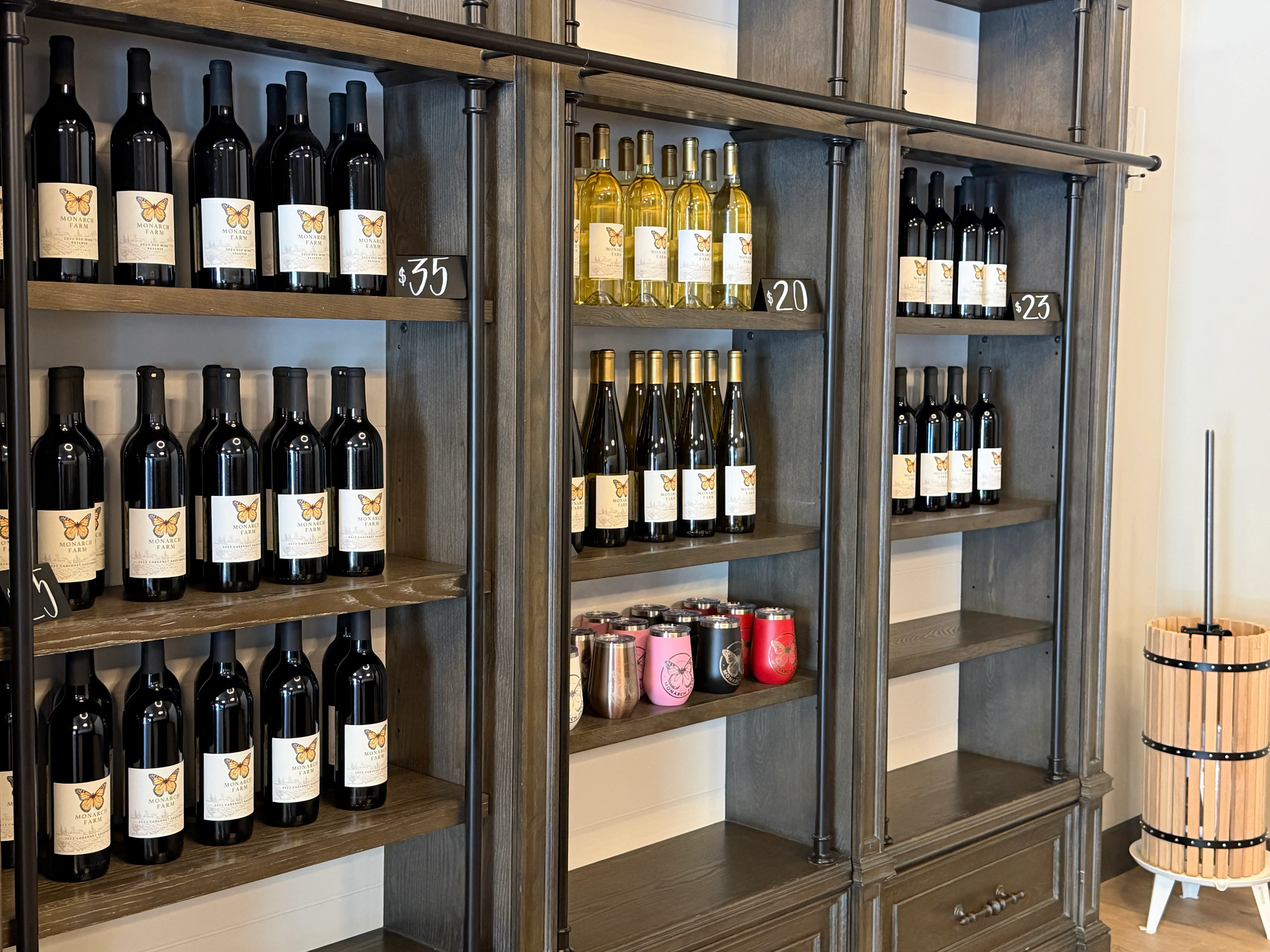 Wine bottles displayed on wooden shelves in a tasting room