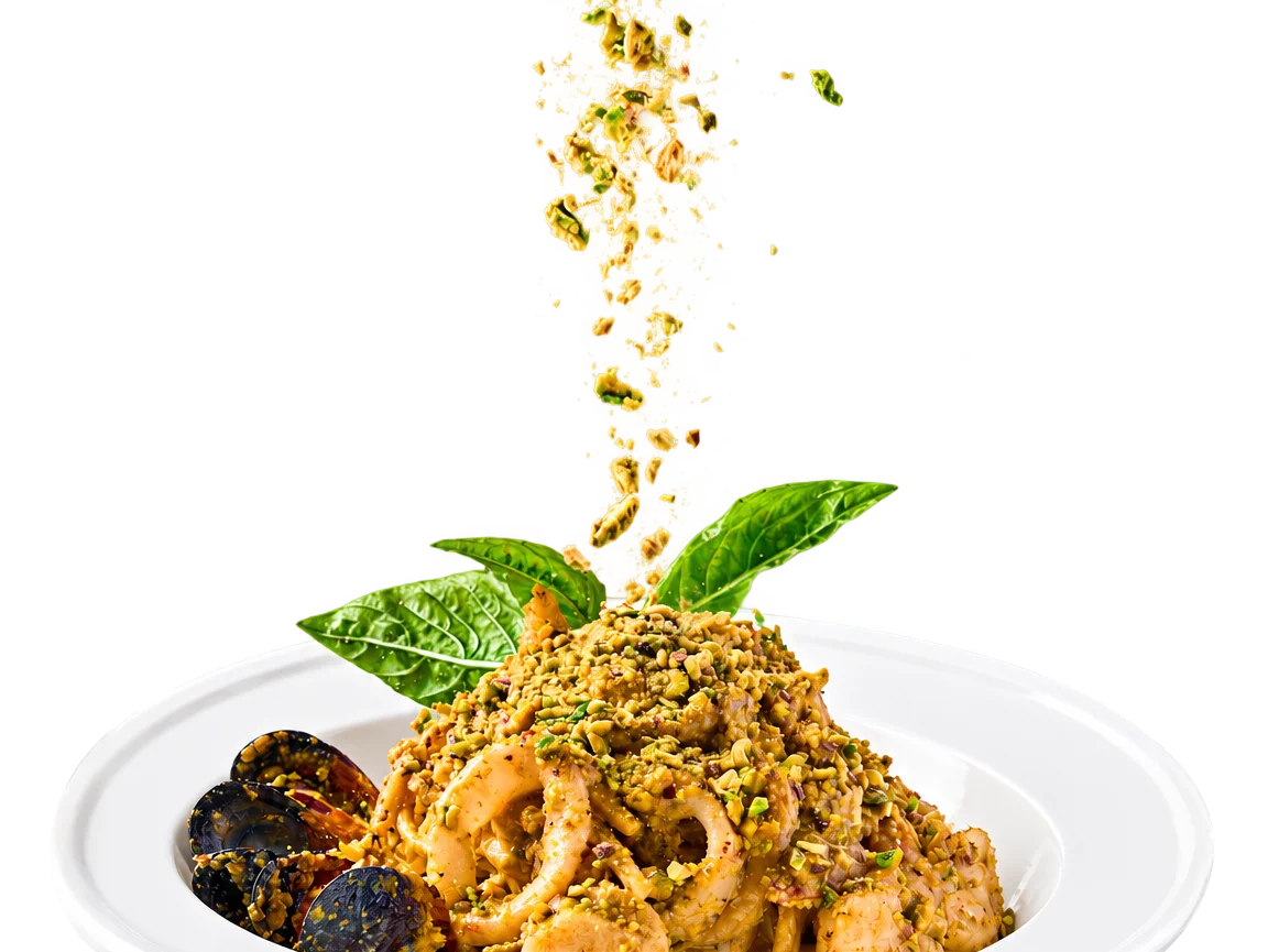 Pistachio pasta dish with seafood and fresh herbs