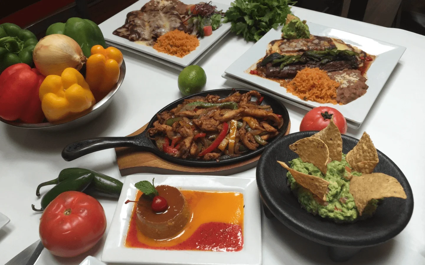 Sizzling fajitas served with guacamole and flan in a Mexican restaurant
