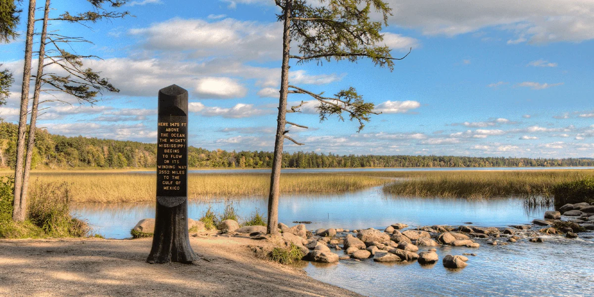 Scenic view of the Mississippi River's source with a historical marker