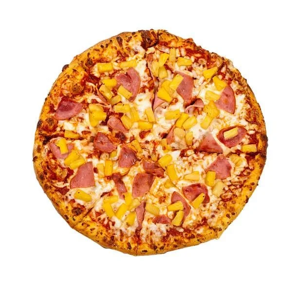 A round pizza topped with ham and pineapple chunks on a cheesy tomato base.