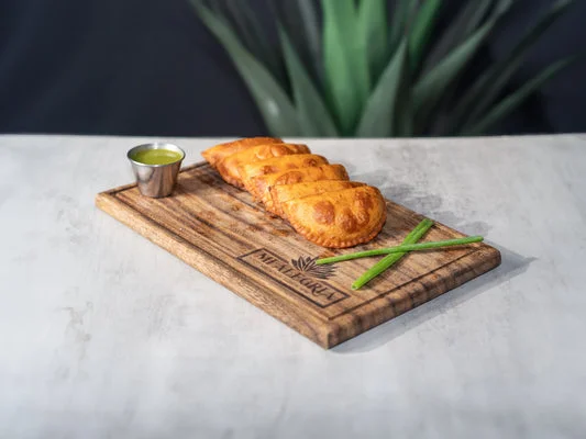 Crispy Indian samosas served with green chutney