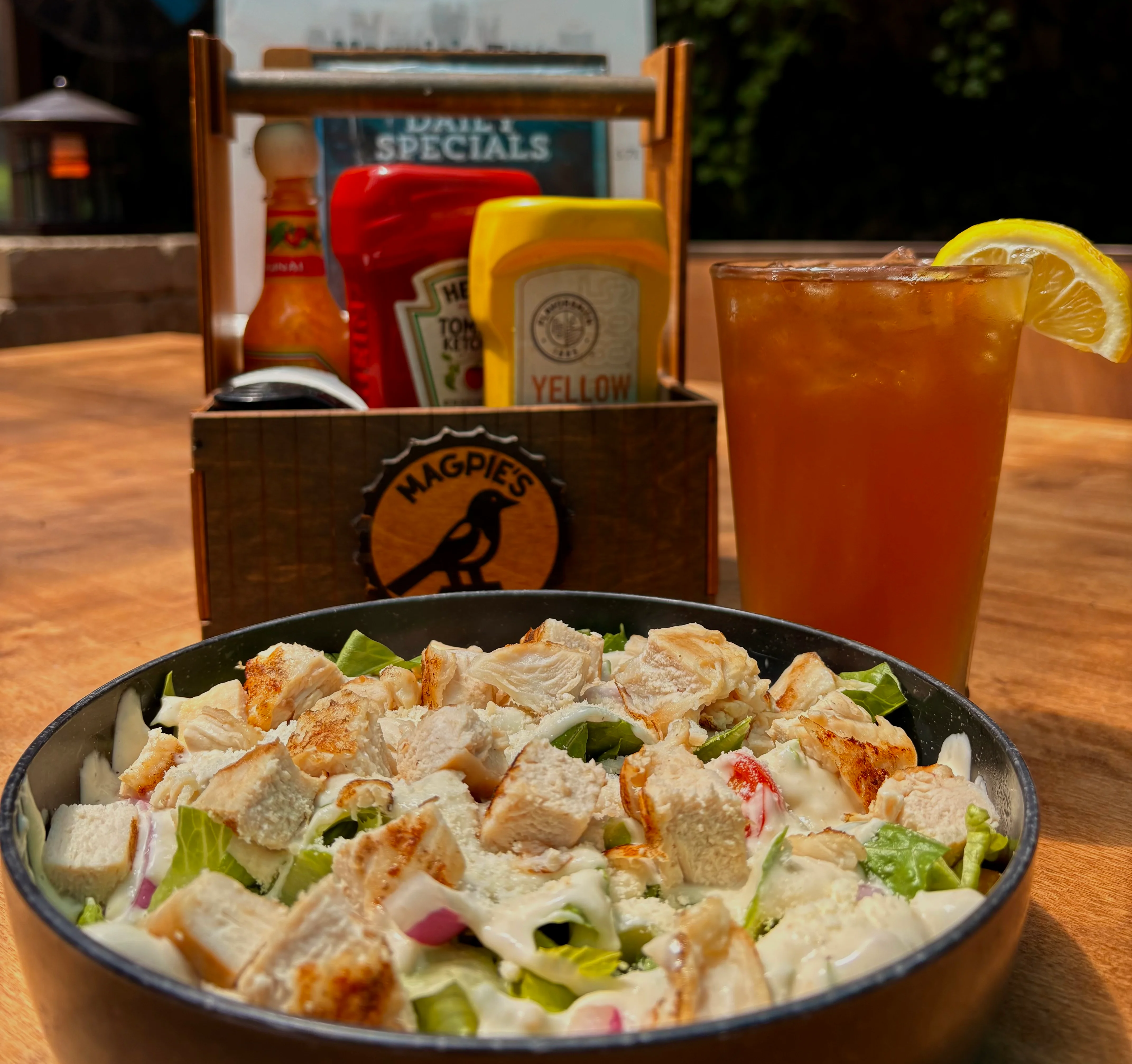 Grilled chicken Caesar salad in a rustic restaurant setting