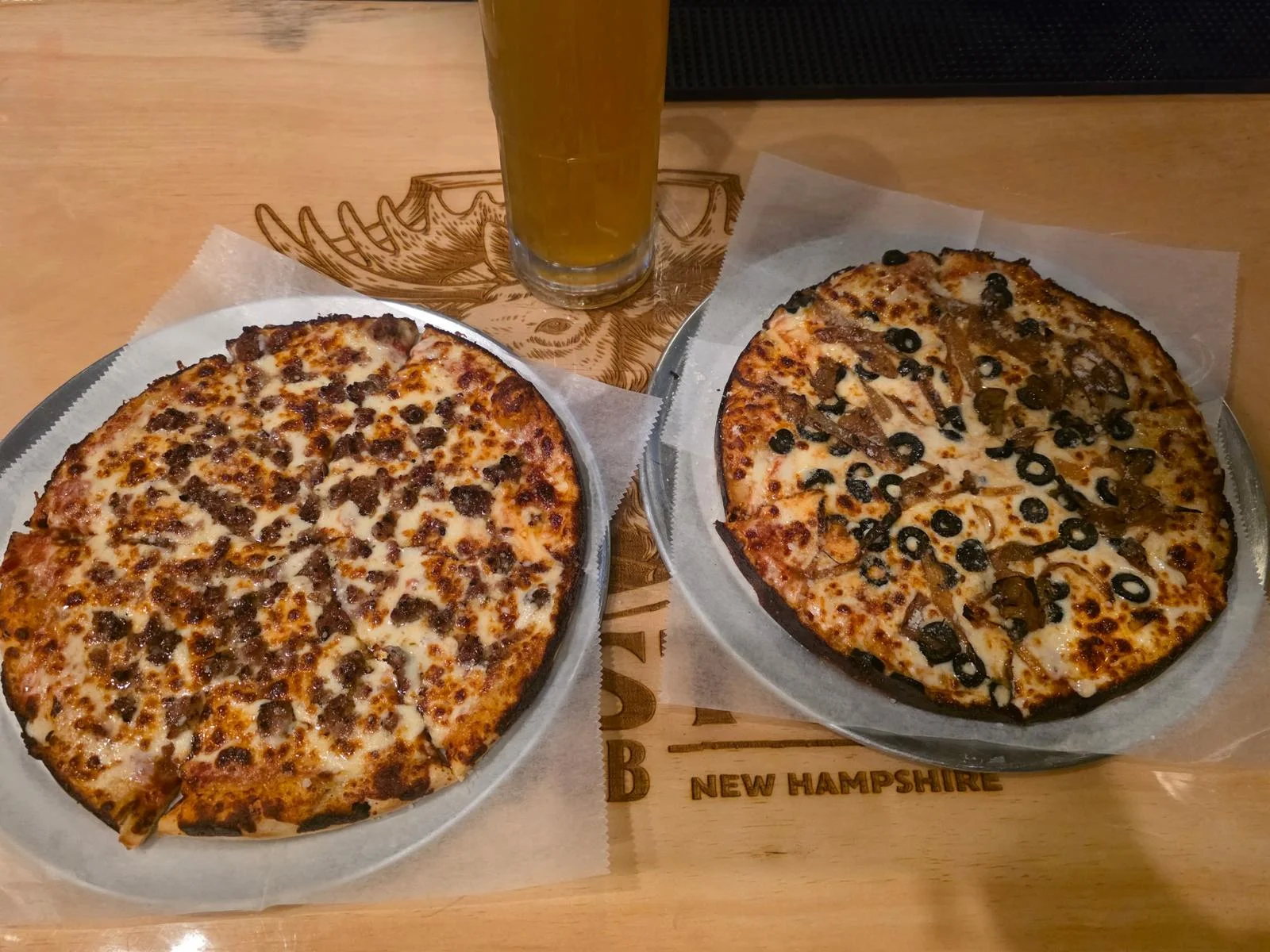 Two pizzas: classic meat and black olive specialty