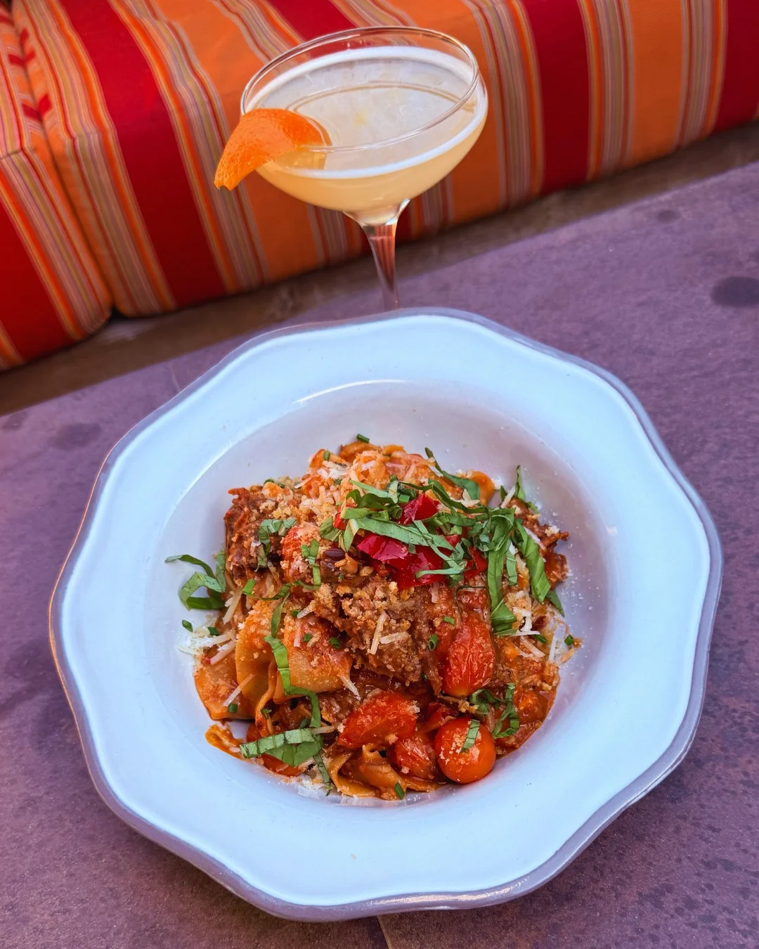 Italian pappardelle pasta with rich tomato sauce and herbs
