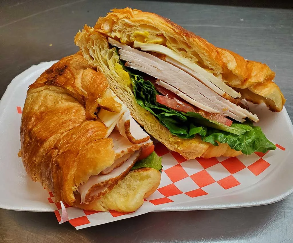 Turkey croissant sandwich with fresh vegetables